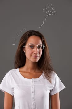 Portrait of a young woman thinking and having great ideas, inventing the future, planning vacations and life. Her imagination is depicted with her face looking towards us and childlike graphics repres