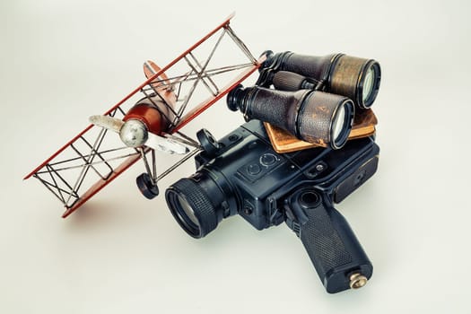 Romantic ideals of adventure depicted with vintage cameras, aircraft, binoculars, and treasure maps. All isolated against a pristine white