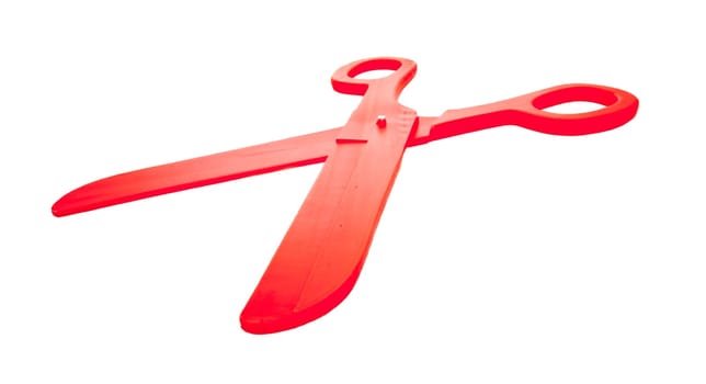 a pair of red plastic scissors in deformed wide-angle perspective and close-up view, isolated on white or transparent