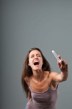 With an athletic leap, a woman throws her cell phone away. Revitalized by anger, she has violent strength and accompanies the gesture with a furious scream. She's had enough!