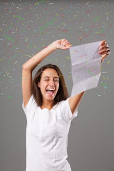 Young woman elated and happy over the written contents of the paper she holds. Her joy seems to stem from excellent news contained in a letter. She cheers with raised arms and laughter. Chaotic graphi