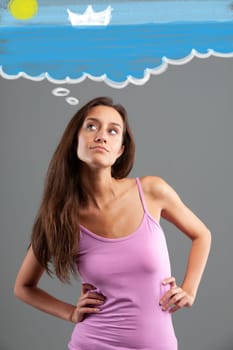 slender young woman with long hair wears a pink tank top  she has her arms akimbo and her hands resting on her hips while a graphic effect shows her dreaming of the sea and vacations