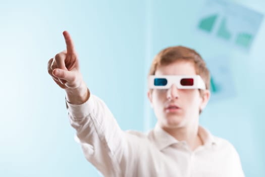 Blurred and focused elements allow you to apply your graphics. A man wearing 3D glasses works in front of himself, hands in the air