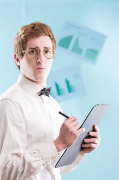 A young man in a dated office suit, perhaps a subservient accountant, with a notepad, white shirt and bowtie, gazes sadly against a generic, blurred office backdrop