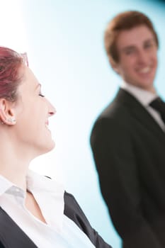 oung man and woman, lost in a shared gaze in an office. Business roles blur in the face of budding romance. Their humanity is undeniable