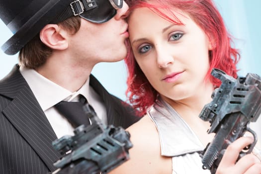 Two worlds collide in a kiss: the bowler hat-wearing superhero spy and his stunning fantasy heroine in silver. With ultrax ray weapons in tow, they find love amidst their action-filled escapades