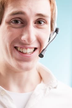 Call center worker in white shirt, amidst blurred background of productivity charts. The real face