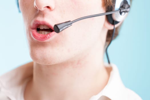 When you think 'contact us,' picture this: close-up of a young man's lips to neck, speaking into a headset. Wearing a white shirt, representing customer assistance, but hailing from an underprivileged