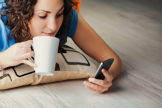 From her home's cushioned floor, a young curly woman plunges into a digital adventure via her phone. Socializing, streaming, gaming, dating, or venturing into adult content, she exploits her device's