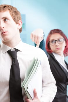 Abusive behavior: A woman showing uncontrolled anger towards a male colleague. Unhealthy workplace environment