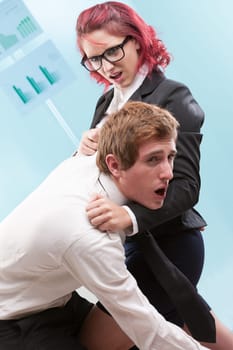 Workplace violence: Woman physically mistreating a man. Excessive power often leads to its misuse
