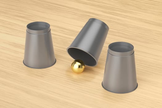 Magic trick with three cups and a gold ball