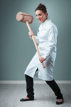 In a blue-green room, a scientist in white ironically wields a 20 KG wooden club. This exaggerated depiction humorously highlights the lack of precision and the potential harms of not adhering to stri
