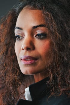 Engrossed in concerns, this black woman's beauty is an unconscious advantage. Mother, wife, and executive, she has much at stake