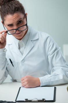 skeptical scientist with black glasses expresses frustration. Upset by pseudoscience, she's devoted her life to true scientific pursuits, dismayed by those spreading misinformation