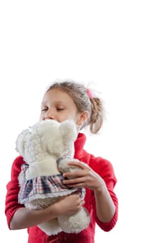 A girl in a red sweater revels in the comfort of her white teddy bear, her companion in play, cuddling, hugging, and even throwing it