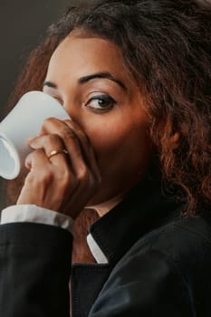 Drinking her espresso, a striking black woman's gaze holds power. In business and high society, she's a force, knowing that with knowledge comes choice, and she embodies freedom through choice