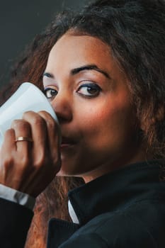 An enchanting black woman drinks her espresso, eyeing the surroundings. Climbing business and societal ranks wasn't accidental it stemmed from being informed, choosing, and adding her sweetness to li