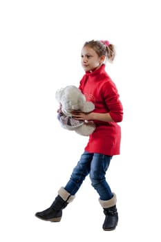 Loving her white teddy bear, a girl in a red sweater explores play, friendship, cuddles, hugs, and tosses - a reassuring soft presence