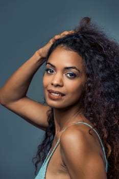 The captivating dance of a brown-skinned woman resonates with beauty and positive vibes. Basking in nature, music, and sunlight, her harmonious energy is a sight to behold