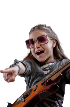 Young girl on a velvet baroque armchair, basking in artist's joy with her electric guitar and sunglasses, in her make-believe concert