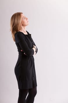 Envisioning a future, a woman's face tells tales of smiles and adventures. Her flowing blond hair and hopeful blue eyes gleam. Playing with her ring, her spiritual connection nurtures a creative spiri