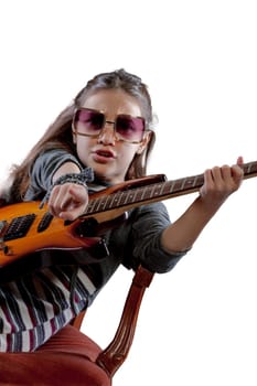 Imaginary pop-rock star, a young girl with an electric guitar, sunglasses, perched on a velvet baroque armchair, basking in adulation