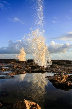 Blowholes at Cadiz city coastline sending burst of water high into the air, Spain