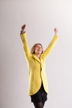 blonde woman extends her arms, embodying pure elation. Gazing at the sun, she's overwhelmed with gratitude. Her contentment shines as she listens to her body and soul, even after 40