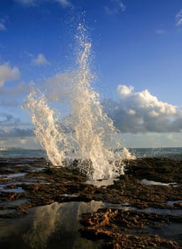 Blowholes at Cadiz city coastline sending burst of water high into the air, Spain