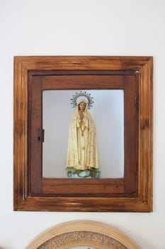 Losar de la Vera, Spain - Augt 8th, 2022: Niche with the image of the Virgin of Fatima at headboard. These itinerant chapels are shared among several neighbors