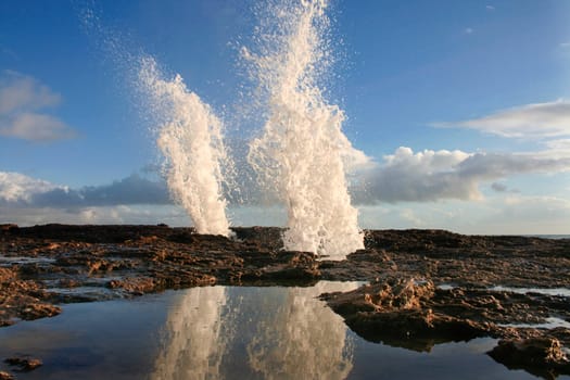 Blowholes at Cadiz city coastline sending burst of water high into the air, Spain