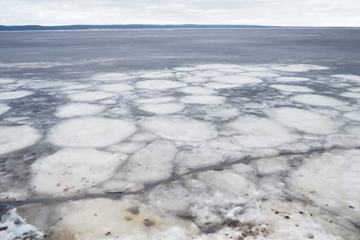 Ice drift in spring on Lake Onega, Karelia. Dangerous thin spring ice in April. Aggregate accumulations of fine-crystalline grains. Opening of small lakes, ponds and reservoirs. Crushed ice floes.