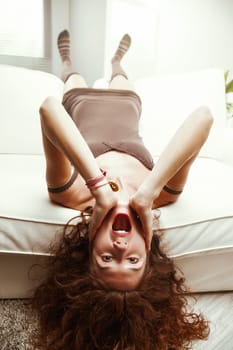 Amplifying the scream's drama, a redhead on her white sofa, replicates Munch's masterpiece. Her stiff posture and exaggerated shock merge comedy with drama, manifesting an unforgettable 'OMG" lifestyl"