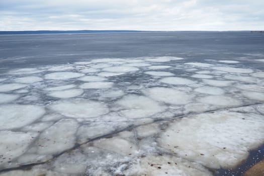 Ice drift in spring on Lake Onega, Karelia. Dangerous thin spring ice in April. Aggregate accumulations of fine-crystalline grains. Opening of small lakes, ponds and reservoirs. Crushed ice floes.