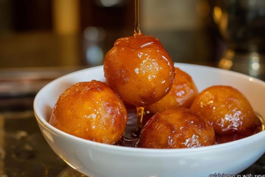 Golden balls of gulab jamun glisten with syrup, ready to be savored.