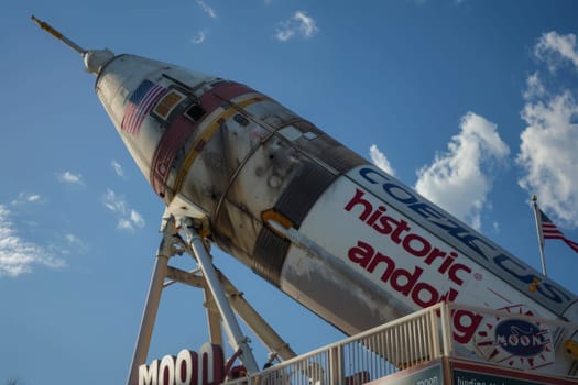 A large rocket is perched on top of an intricate metal structure, ready for lift-off into the great unknown.