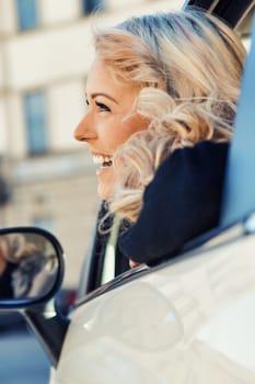 Meet a curly-haired blonde, makeup on point, exploring Europe in a cute, classy car. As she drives, she smiles and poses, letting her gorgeous eyes be the stars, sometimes sun-shaded