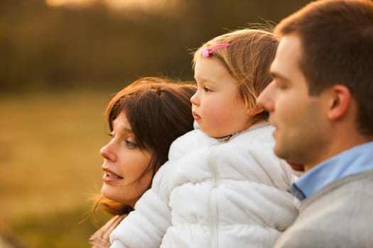 'Look, daughter, the valley's beauty won't be yours' Loving parents and child share an autumnal moment, basking in nature's hues and dreaming of what lies ahead