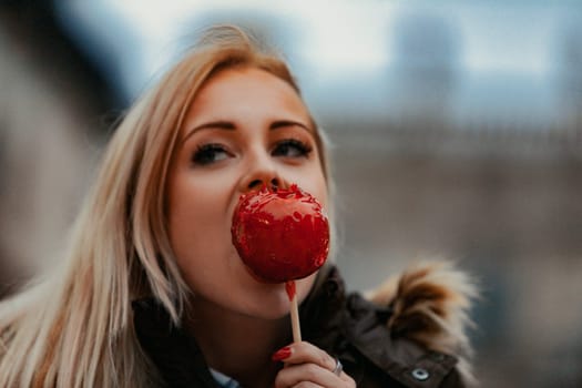 oung blonde woman bites a caramel apple, captivated by the artistic and architectural landmarks that epitomize the heart of Western civilization. Pleasing to both palate and eyes
