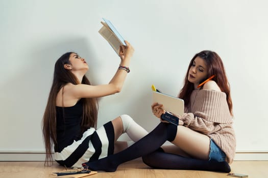 Amidst crowds, two girls experience the paradox of connection: smartphones and social media versus rich, historical physical mediums. Will we surpass our predecessors or falter?