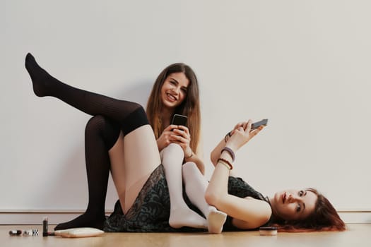Reveling in youth, two women embrace self-expression, aware that societal judgments may later confine them
