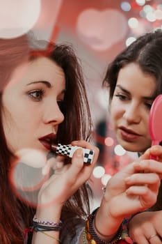 Embodying youthful allure, two women touch up their makeup in a club. Their desire is to feel and be desired as they live the night fully