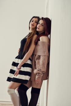 Distinct styles tell their story: one's relaxed elegance, the others black-and-white precision. Combined with thigh-highs and makeup, they flaunt transient beauty
