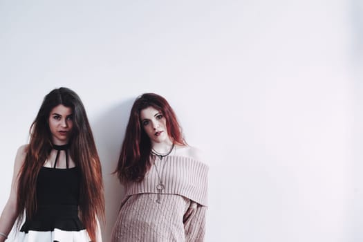 Captured are friends: one in effortless glam, the other in a two-toned dress. Their chosen attires, makeup, and poses exude a beauty they enjoy while it lasts