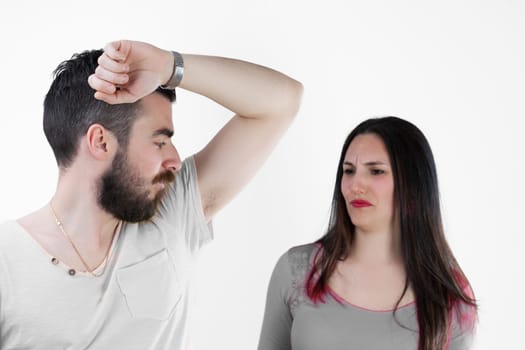 'Your armpits smell of sweat!' A man and woman confront the issue of excessive sweating without deodorant. The evident 'stained armpit' underscores the importance of managing natural bodily functions