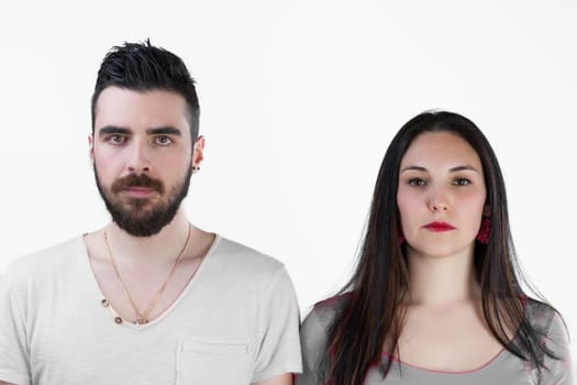 Frontal view of a man and woman, side by side, their expressions blank or sad. Relationship in question or crisis, communication issues? Simply suffering life's blows together. He's bearded, she with