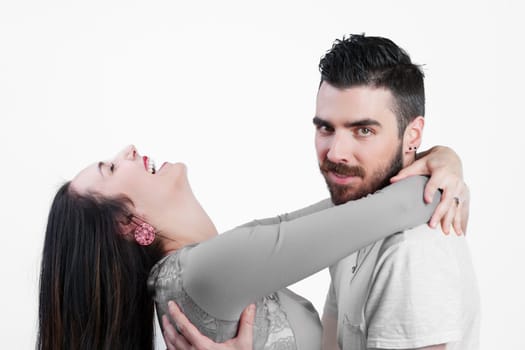 On a white background, a proud young man, feeling virile, is embraced by a joyful woman. Despite self-value, recognition in relationships always depends on the other, highlighting relational interdepe