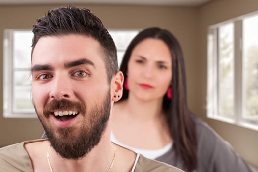 Photomontage: a man posing sly and strong. Behind, his wife's disapproval is palpable. He's acting cool, her scolding is imminent. Classic, humorous household discord depicted