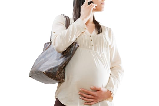 Professional looking pregnant woman on phone, white isolated backdrop. Face hidden, carrying a sizable shoulder bag